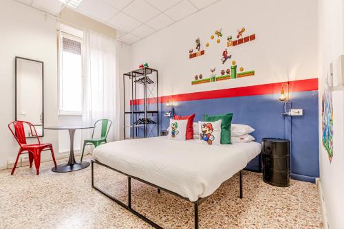 a bedroom with a bed and a table and chairs at Game Rooms Experience in Livorno