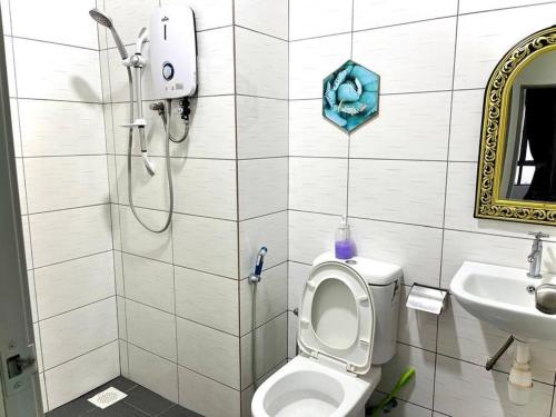 a bathroom with a shower and a toilet and a sink at Ammara Homestay 3 Palas horizon Kea Farm in Cameron Highlands