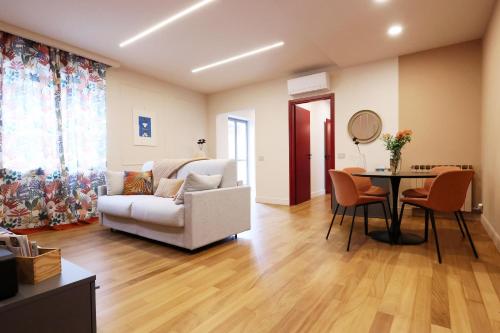 a living room with a couch and a table at All'Angolo Deluxe Apartment in Alba