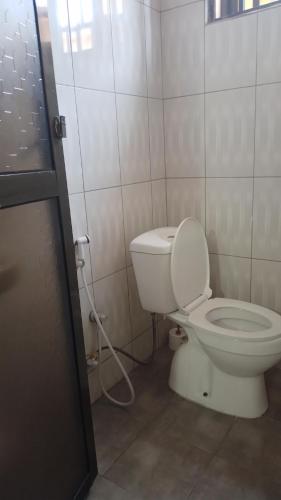 a bathroom with a white toilet in a room at CoolHome at Mbezi Beach in Dar es Salaam