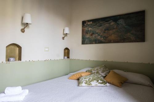 a bedroom with a bed with two pillows on it at CRISPI DELUXE 2 bedroom in Rome