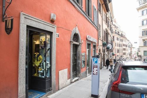 a red building with a parking meter in front of a store at CRISPI DELUXE 2 bedroom in Rome