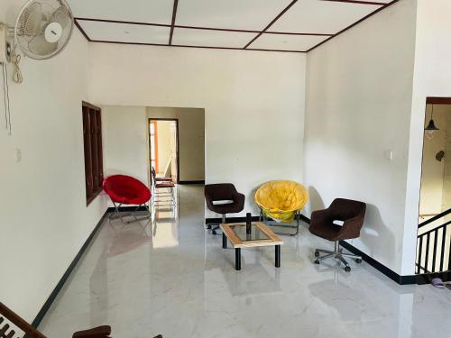 a living room with chairs and a table at Dream Holiday Home Badulla in Badulla
