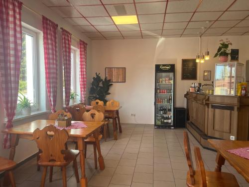 a restaurant with tables and chairs in a room at Truckcenter Fehrbellin an der A24 in Fehrbellin