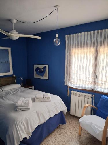 a blue bedroom with a bed and a window at Bungalow CASIOPEA Internet 300 Mb SAT SMARTTV in El Campello