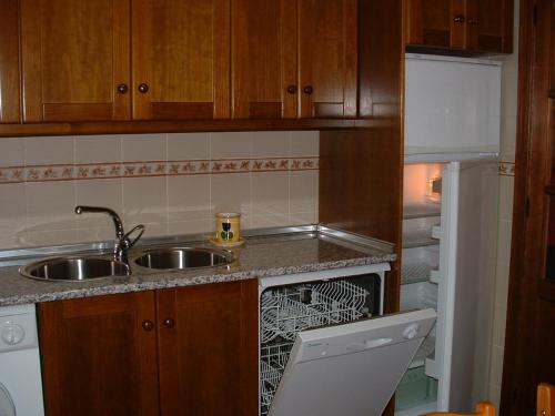 a small kitchen with a sink and a dishwasher at Casa Rural Cendal in Navacarros
