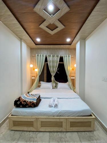 a bedroom with a bed with two towels on it at Scenic Village Stay near Kufri With Bonfire & Veg Meals-Alpine Crest Homestay Kufri in Theog