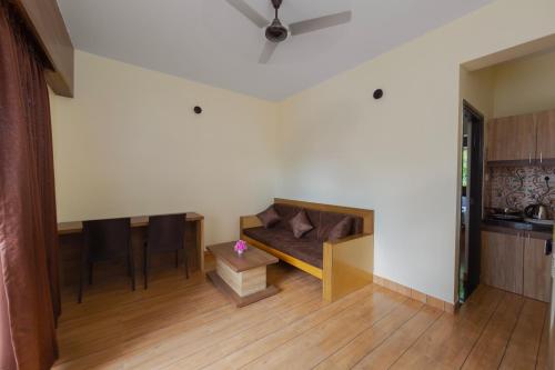 a living room with a couch and a table at Lykke Suites- 2-min Drive to Colva Beach-By Goan Felicidade Hospitality PVT LTD in Colva
