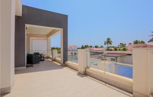 a balcony of a house with a swimming pool at Cozy Home In El Chaparral in La Mata
