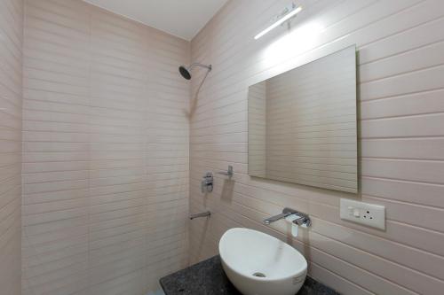 a bathroom with a sink and a mirror at Lykke Suites- 2-min Drive to Colva Beach-By Goan Felicidade Hospitality PVT LTD in Colva