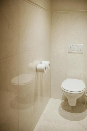 a bathroom with a toilet and a glass door at Pension Baranekhof - closest to the Kitzsteinhorn Ski Resort in Kaprun