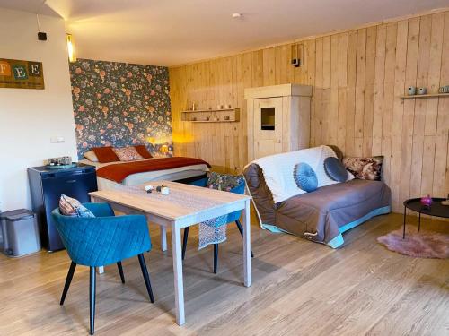 a living room with a couch and a table at La Maison des Senteurs in Francorchamps