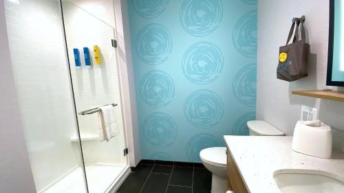 a bathroom with a shower and a toilet at Tru By Hilton Baltimore Harbor East in Baltimore