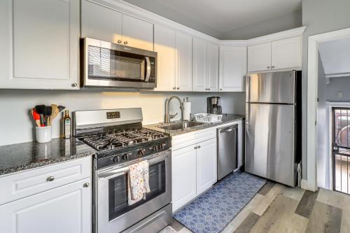 a kitchen with white cabinets and stainless steel appliances at Downtown Detroit Townhome Near North End! in Detroit