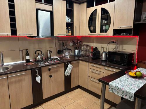 a kitchen with wooden cabinets and a counter top at E'milu Residence in Ghimbav