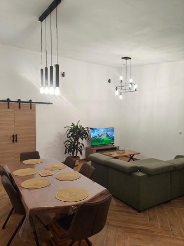 a living room with a table and a couch at Maison individuelle in Oignies