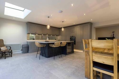 a large kitchen with a island in the middle at Bellevue Period House in County Armagh in Bessbrook