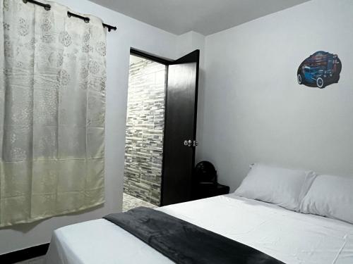 a bedroom with a bed and a walk in shower at Hogar El Descanso Itagui in Itagüí
