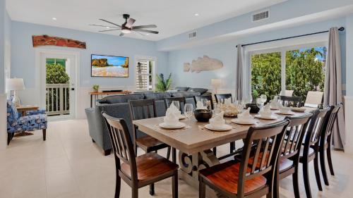 a dining room and living room with a table and chairs at A Royal Affair by Last Key Realty in Key West