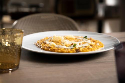 a plate of food on a table with a drink at Furrìa in Vizzini