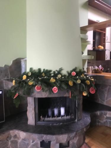 a fireplace with a christmas wreath on it at Apartament Mickiewicza in Przemyśl