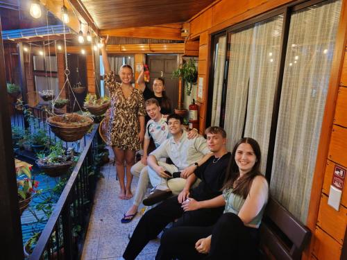 a group of people sitting in the back of a house at Cabinas El Pueblo B&B Monteverde in Monteverde Costa Rica