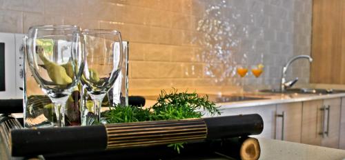 a table with two wine glasses and a book at Alojamiento Rural El Lario in Alcalá de los Gazules