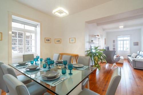 a dining room with a glass table and chairs at Villa Oasis Sea View - 3 Bedrooms in Funchal
