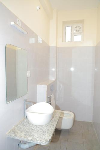 a bathroom with a white sink and a toilet at PRS CREEK SIDE HOME STAY VILLA in Yelagiri
