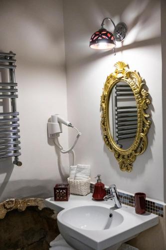 a bathroom with a sink and a mirror on the wall at B & B Boutique Epoca in Salerno