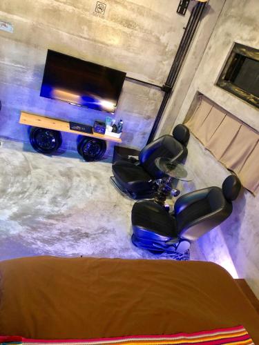 an overhead view of a living room with a table and chairs at 巴斯拉岸民宿 in Chenggong