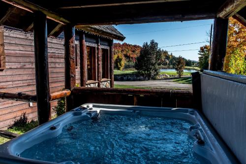 a hot tub in the backyard of a house at Royal Laurentien in Mont-Blanc