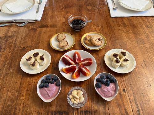 a table topped with plates of pastries and cookies at Il Fiume Azzurro Home B&B in Castelletto sopra Ticino