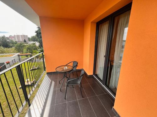 a balcony with a table and a chair on it at Penzion Na Svahu in Cheb