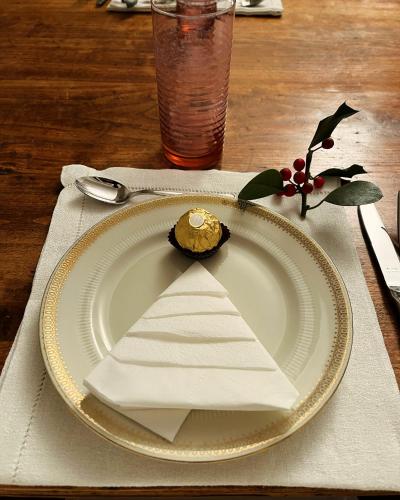 a white plate with a napkin on a table at Il Fiume Azzurro Home B&B in Castelletto sopra Ticino