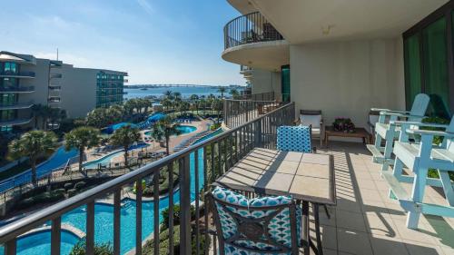 a balcony with chairs and a view of a pool at Phoenix on the Bay 1414 condo in Orange Beach