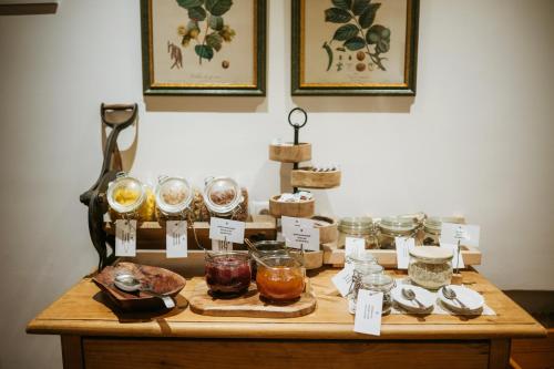 a table with many different types of food and drinks at Pension Baranekhof - closest to the Kitzsteinhorn Ski Resort in Kaprun