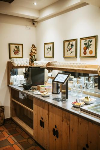 a restaurant with a counter with food on it at Pension Baranekhof - closest to the Kitzsteinhorn Ski Resort in Kaprun