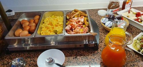 a table with a tray of breakfast food on it at Hotel Astor in Wuppertal