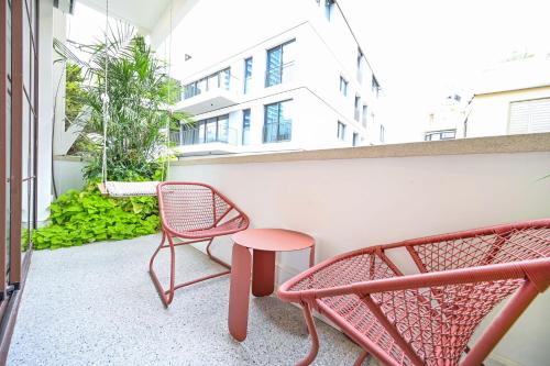 a balcony with two chairs and a table at Charming 1BR Dizengoff by HolyGuest in Tel Aviv