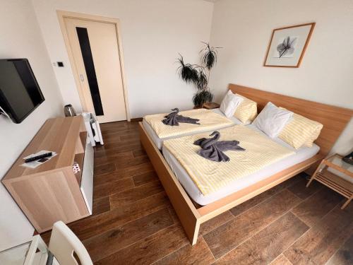 a bedroom with a bed with towels on it at Penzion Na Svahu in Cheb