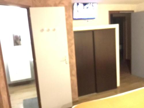 a room with a desk and a tv on a wall at Hôtel Bellevue Bagnoles Normandie in Bagnoles de l'Orne