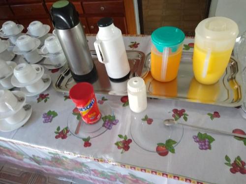 a table with some cups and cups on it at La Riviera Pousada Pantanal in Itanhaém