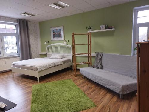 a bedroom with two beds and a green wall at Salon Till in Magdeburg