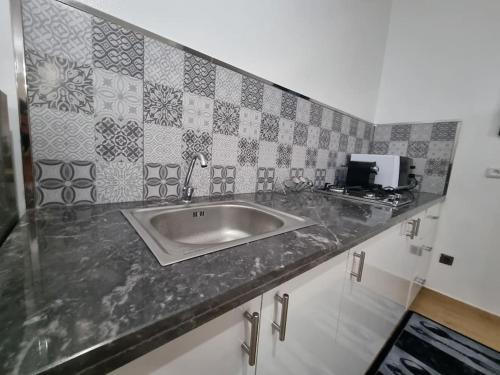 a kitchen with a sink in a counter top at Spacious and Modern 2BR Apartment Rabat center in Rabat