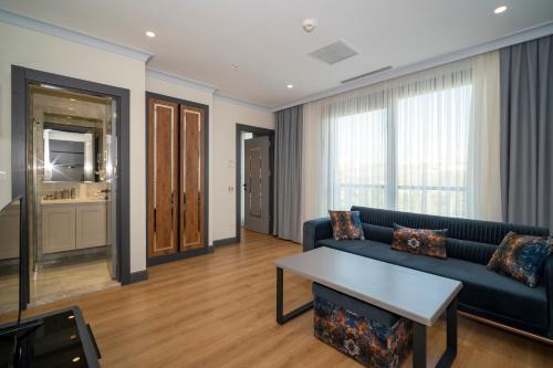 a living room with a couch and a table at Rusel Park Residence in Bahcesehir