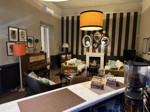 a living room with a couch and a piano at Hotel Le Focette in Marina di Pietrasanta