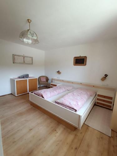 a bedroom with a large bed in a room at Ferienwohnung Marchnerhof in Terento