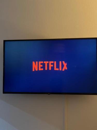a television with a netflix sign on a wall at Teps home Airport Venice in Venice