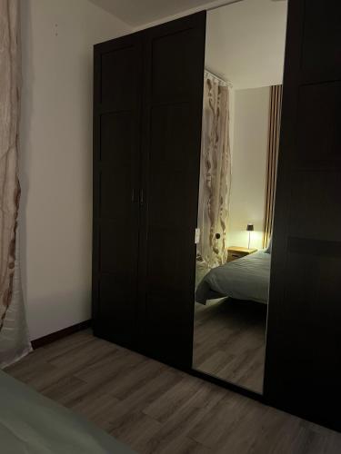 a mirror in a room with a bed and a bedroom at Teps home Airport Venice in Venice